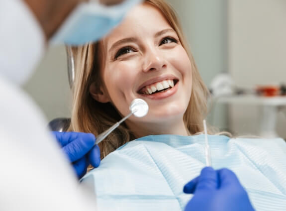 Dental patient smiling at her dentist