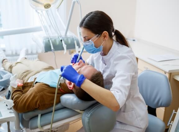 Emergency dentist treating a patient