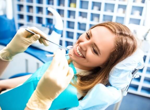 Young woman smiling right before receiving root canal treatment